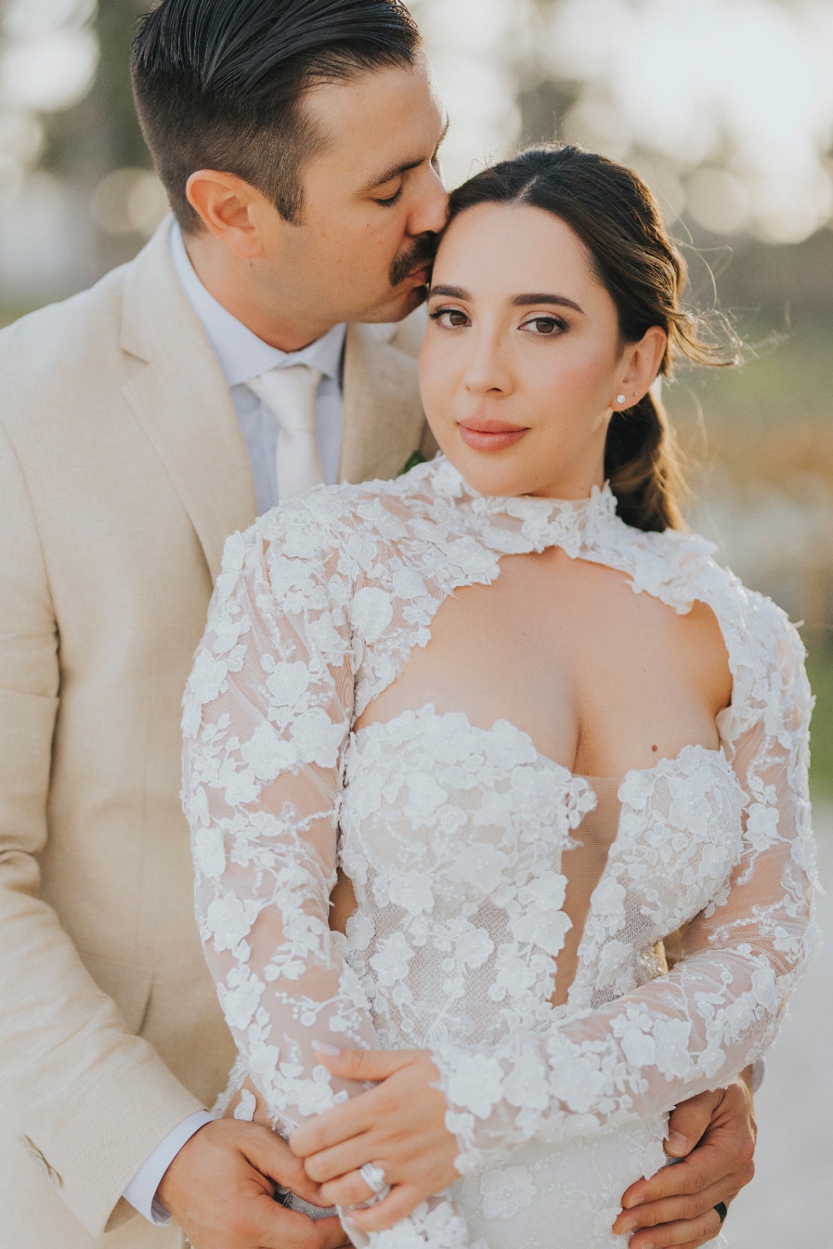 Bride in soft updo and luminous skin-first makeup at golden hour, Punta Cana beach portrait