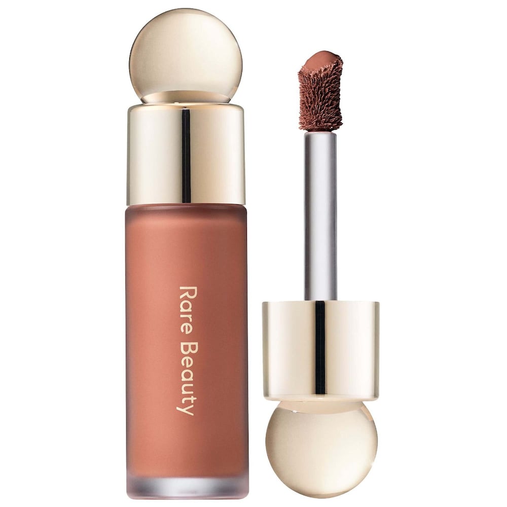 Rare Beauty Soft Pinch Liquid Blush in Virtue, beige-peach liquid bottle with gold cap and doe-foot applicator